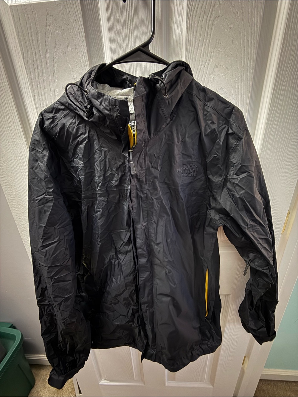 The North Face packable Black Hooded Rain Jacket with Yellow Accents